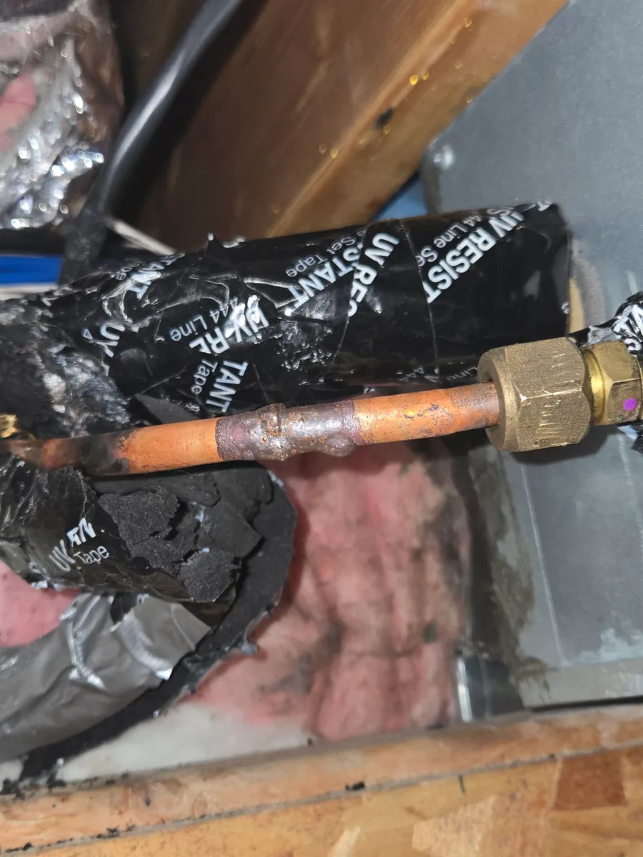 The finished brazed copper joint on the mini-split refrigerant line, in place of the quick-connect fitting that leaked