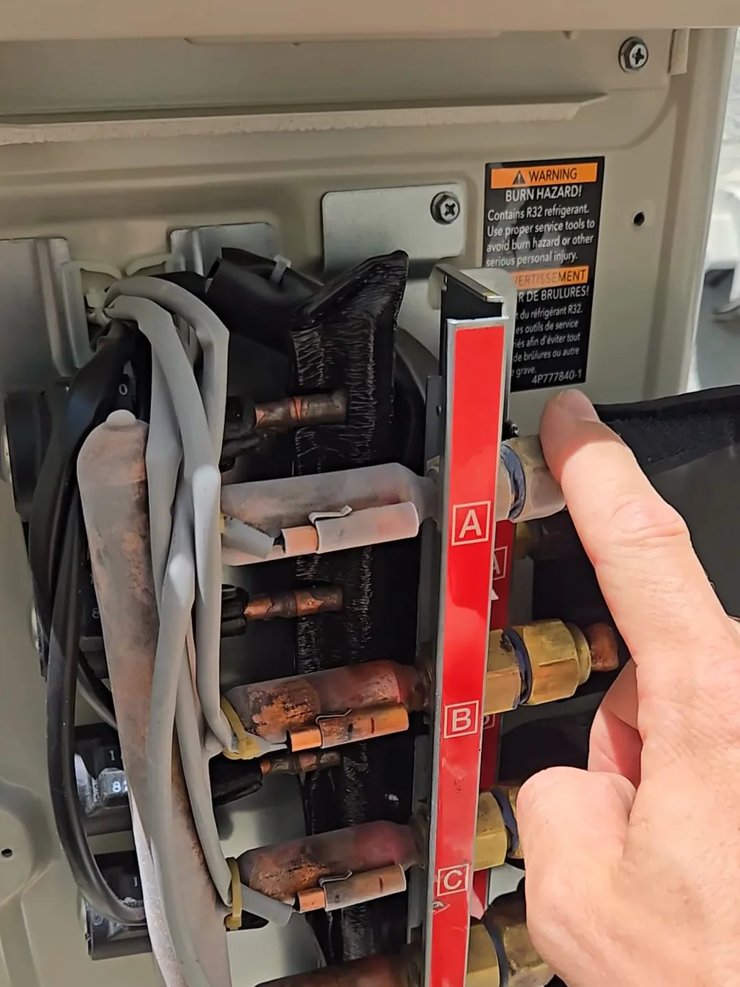 The frosted refrigerant line on the zone that was switched off — cold refrigerant flowing through a unit with no airflow.