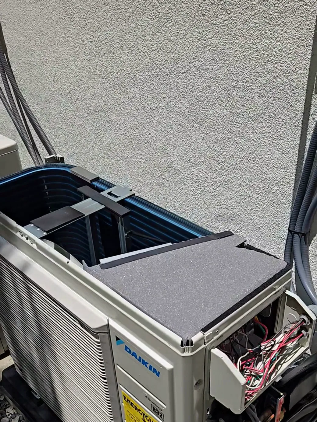 A brand-new Daikin multi-zone mini split outdoor unit with its service panel open during diagnosis in Los Angeles.