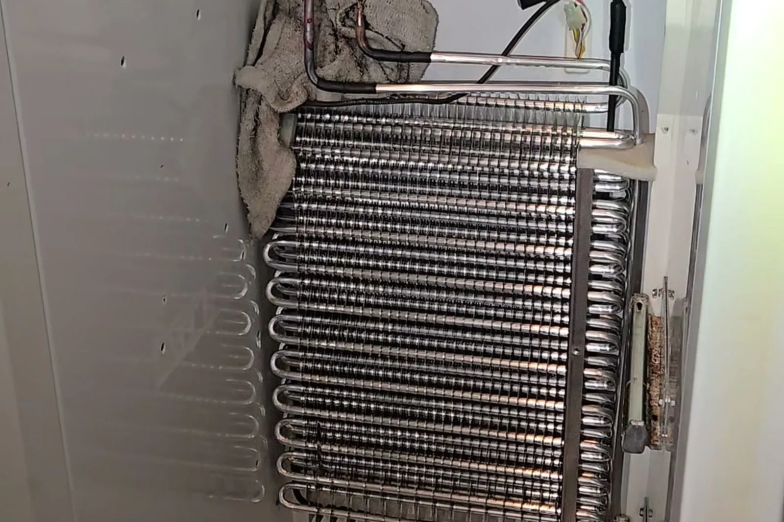 New OEM evaporator coil installed in the freezer compartment of the KitchenAid built-in refrigerator