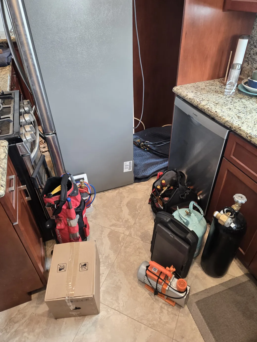 Refrigerant recovery machine, vacuum pump, and nitrogen tank set up in the kitchen for an LG sealed-system compressor replacement in Los Angeles.