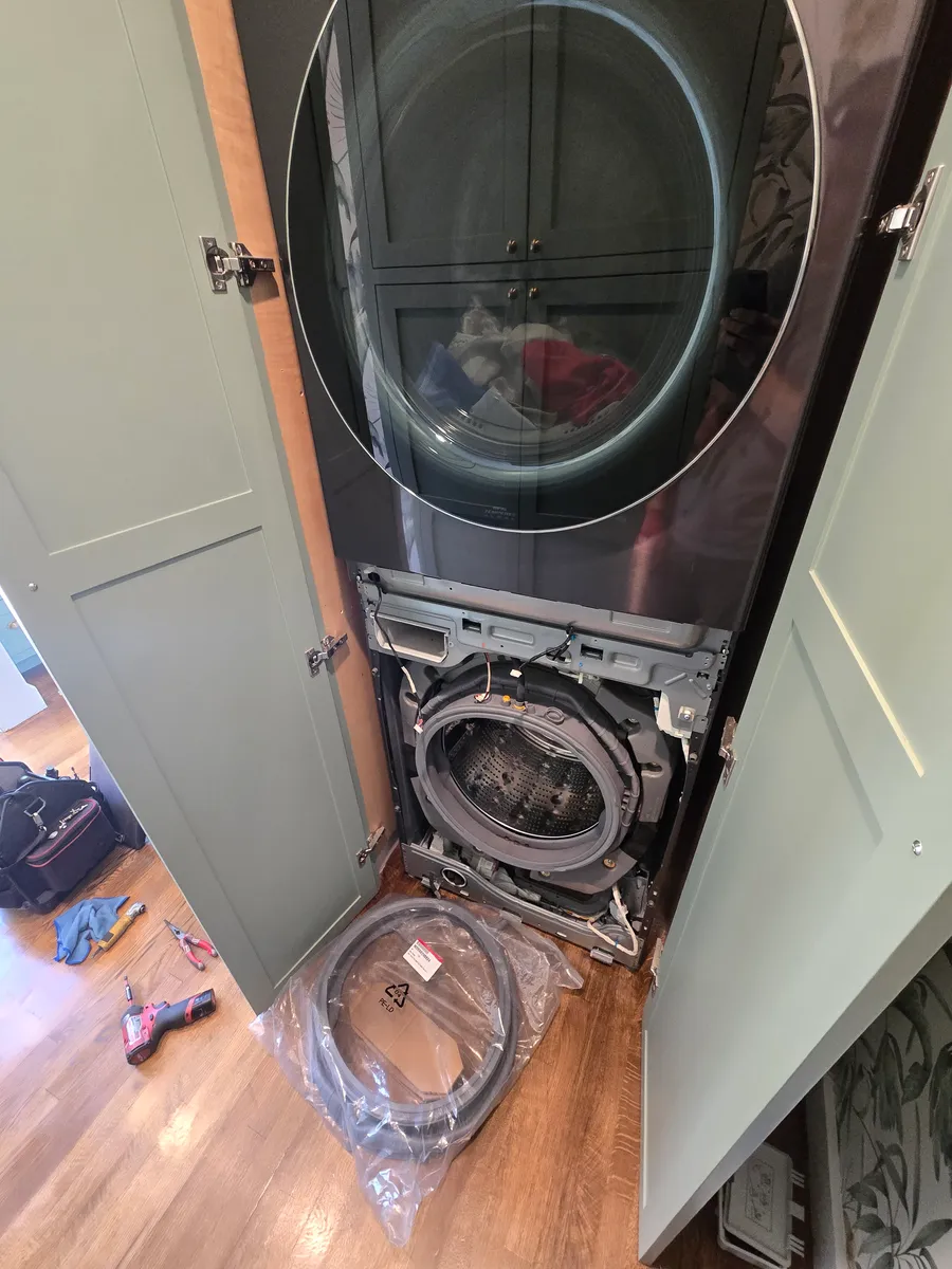 LG WashTower stacked washer and dryer with the front panel off during door boot replacement in Los Angeles