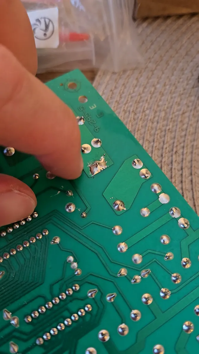 Oven control board with the burnt bake element relay removed and contact pads cleaned