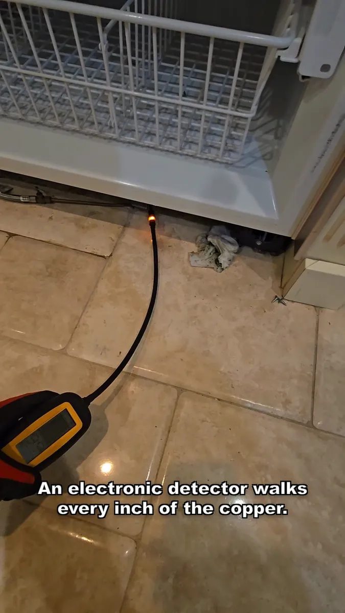 Electronic leak detector tracing the copper lines under the Sub-Zero