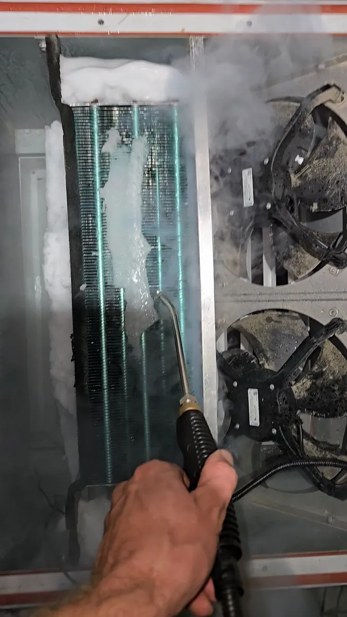 Steam defrost melting ice off the walk-in cooler evaporator coil