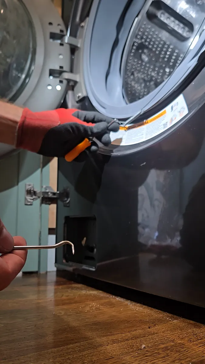 Two hooks installing the outer spring of the LG WashTower door boot