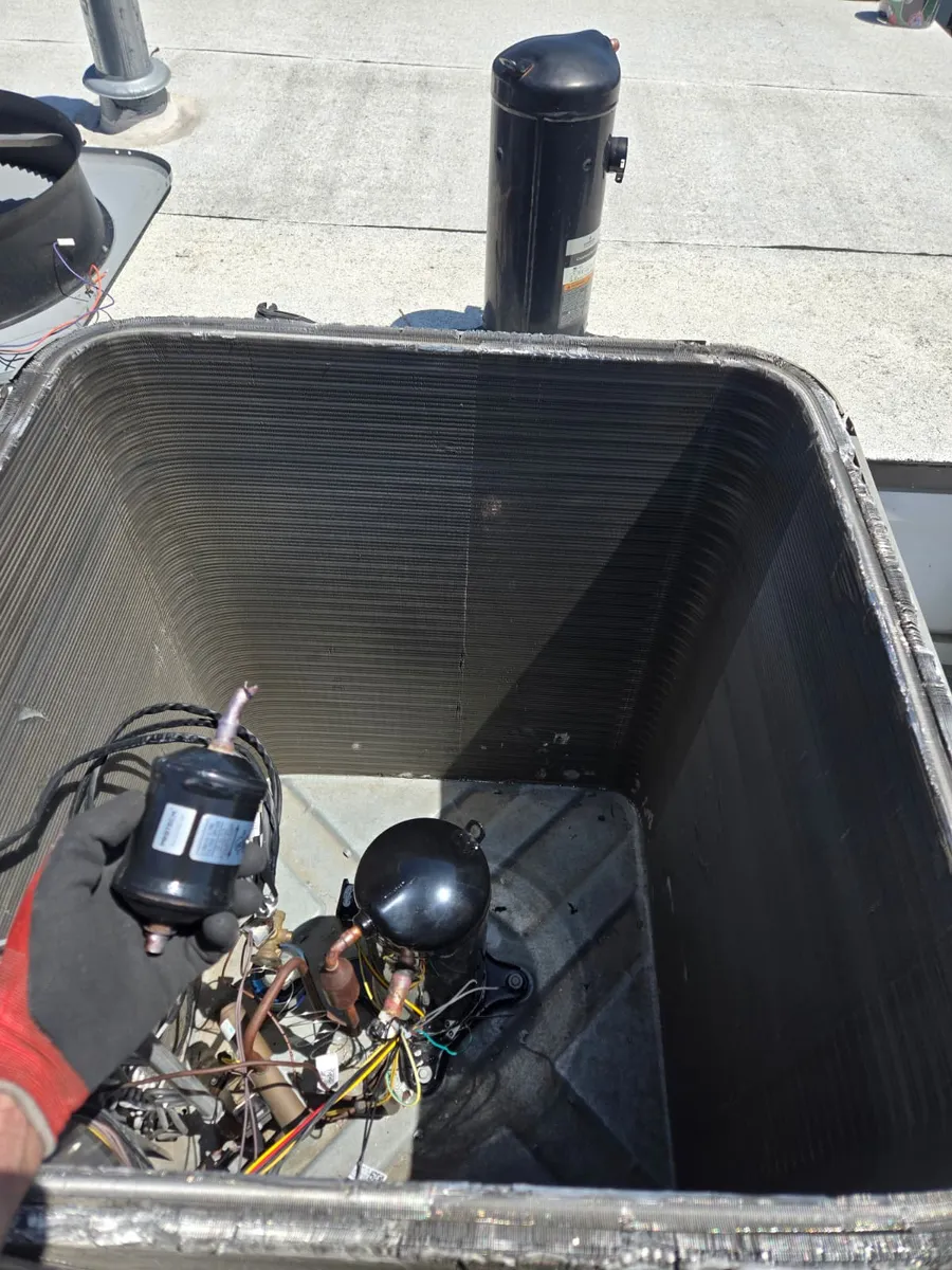 Compressor and wiring inside a commercial rooftop AC unit serviced by Epic Star in Playa Vista, CA